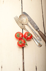 Image showing ripe cherry tomatoes over white wood