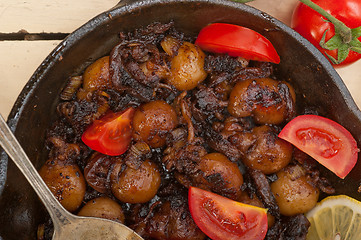 Image showing Baby cuttle fish roasted on iron skillet