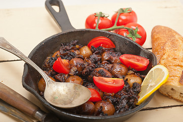 Image showing Baby cuttle fish roasted on iron skillet