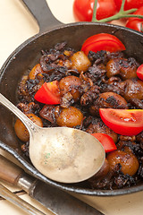 Image showing Baby cuttle fish roasted on iron skillet