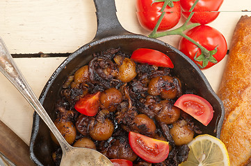 Image showing Baby cuttle fish roasted on iron skillet