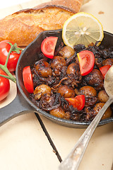 Image showing Baby cuttle fish roasted on iron skillet