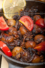 Image showing Baby cuttle fish roasted on iron skillet