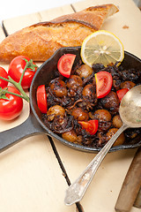 Image showing Baby cuttle fish roasted on iron skillet