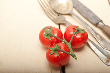 Image showing ripe cherry tomatoes over white wood