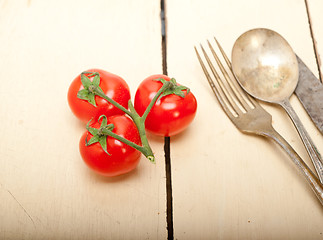 Image showing ripe cherry tomatoes over white wood