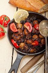 Image showing Baby cuttle fish roasted on iron skillet