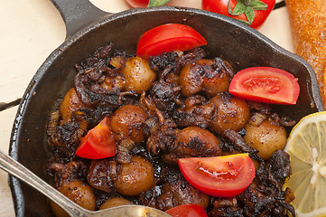 Image showing Baby cuttle fish roasted on iron skillet