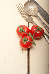 Image showing ripe cherry tomatoes over white wood