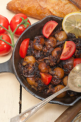 Image showing Baby cuttle fish roasted on iron skillet