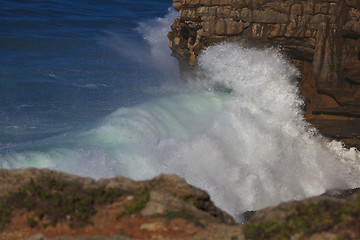 Image showing Marine wave breaks against offshore stone