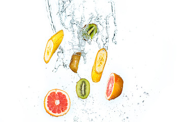 Image showing Fresh fruits falling in water splash, isolated on white background