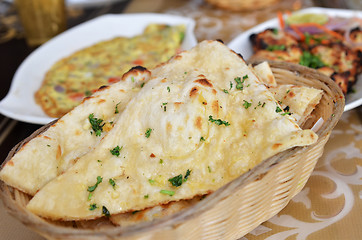 Image showing Garlic and coriander naan on a basket