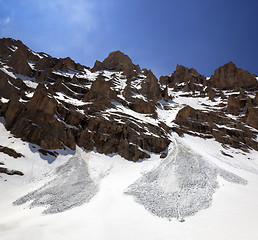 Image showing Snowy rocks and trace from avalanche in spring