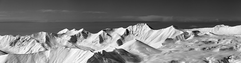 Image showing Black and white panoramic view on off-piste slope and snowy plat