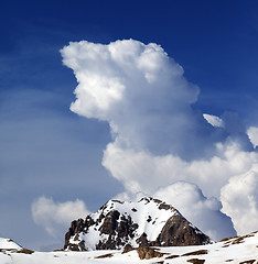 Image showing Rocks in snow and blue sky with clouds