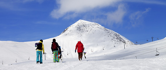 Image showing Three snowboarder on slope at sun nice day