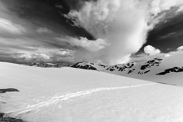 Image showing Black and white view on snowy mountains and sky with clouds