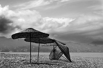 Image showing Black and white old sunshade on deserted beach