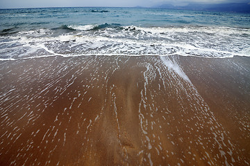 Image showing Sea beach with waves in gray day