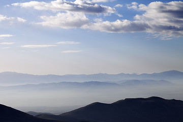 Image showing Silhouette of mountains in fog at early morning