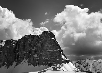 Image showing Black and white view on snowy rocks and sky with clouds in nice 