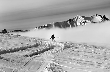 Image showing Snowboarder downhill on off-piste slope with newly-fallen snow