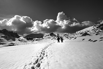 Image showing Black and white view on snow plateau with hikers.