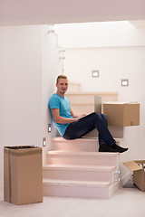 Image showing young man sitting in stairway at home