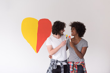 Image showing couple with painted heart on wall