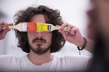 Image showing man with funny hair over color background with brush