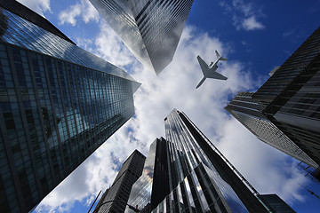 Image showing Airplane in New York City Between Buildings