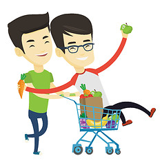 Image showing Couple of friends riding by shopping trolley.