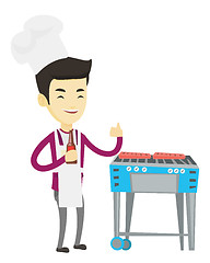 Image showing Man cooking steak on barbecue grill.