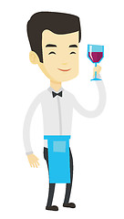 Image showing Bartender holding a glass of wine in hand.