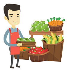 Image showing Supermarket worker with box full of apples.