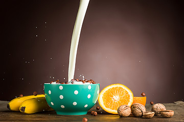 Image showing Healthy home made breakfast of muesli, apples, fresh fruits and walnuts