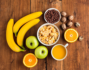 Image showing Healthy home made breakfast of muesli, apples, fresh fruits and walnuts