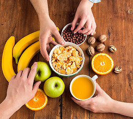 Image showing Healthy home made breakfast of muesli, apples, fresh fruits and walnuts