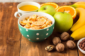 Image showing Healthy home made breakfast of muesli, apples, fresh fruits and walnuts