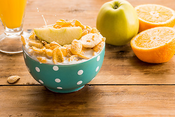 Image showing Healthy home made breakfast of muesli, apples, fresh fruits and walnuts