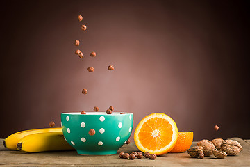 Image showing Healthy home made breakfast of muesli, apples, fresh fruits and walnuts