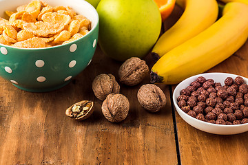 Image showing Healthy home made breakfast of muesli, apples, fresh fruits and walnuts