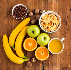 Image showing Healthy home made breakfast of muesli, apples, fresh fruits and walnuts