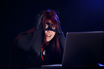 Image showing Surprised brunette next to laptop