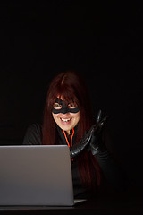 Image showing Female hacker in black mask