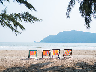 Image showing Four chaise lounges on beach