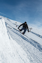 Image showing Snowboarder jumping against blue sky