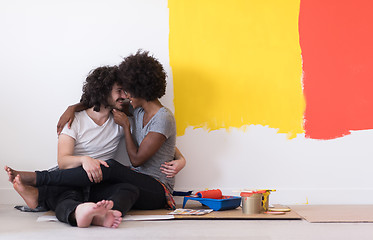 Image showing young multiethnic couple relaxing after painting