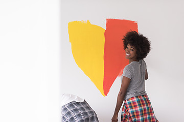 Image showing multiethnic couple painting interior wall